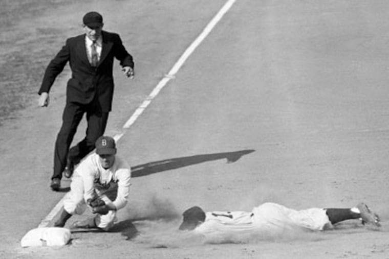 Yankees shortstop Phil Rizzuto is out at third during the first televised World Series in 1947. (John Rooney/AP)
