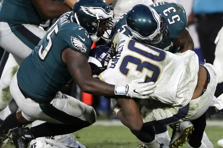 Eagles defensive end Vinny Curry and outside linebacker Nigel Bradham stops Los Angeles Rams running back Todd Gurley on Sunday, December 10, 2017. YONG KIM / Staff Photographer
