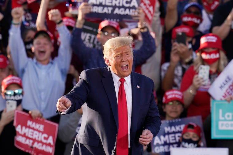 President Donald Trump worked the crowd after speaking at a campaign rally Monday in Tucson, Ariz.