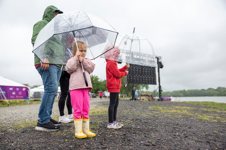Gabby Edwards, 4, of Columbus, Ohio, is with her sister Darla Edwards, 6, her grandpa Denny Fuchs, and his fiance, Julie Wandtke, to support Julie’s daughter who rowed in the women's fours for Tampa University at the Dad Vail Regatta at the Cooper River in Pennsauken on Friday.