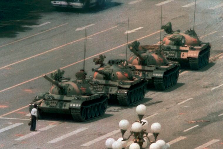 In this June 5, 1989, file photo, a Chinese man stands alone to block a line of tanks heading east on Beijing's Cangan Blvd. in Tiananmen Square. The man, calling for an end to the recent violence and bloodshed against pro-democracy demonstrators, was pulled away by bystanders, and the tanks continued on their way. Thousands of students demonstrated for democracy in Tiananmen Square. Hundreds died when the government sent in troops.