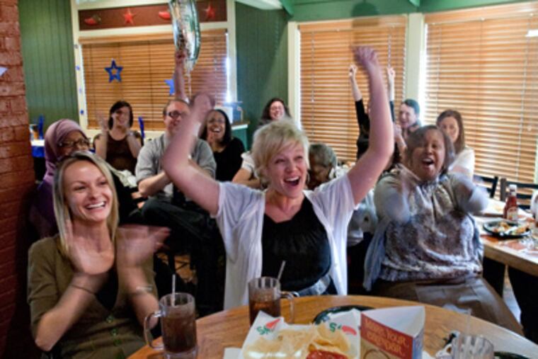 Cheering Mastery’s $1 million grant are staffers (center row, from left) Catherine Brand, Kim Crandall, April Thomas, Sharif El-Maki, and Krissy Kim. The group gathered at a Chili’s to watch the broadcast. (David M Warren / Staff Photographer)