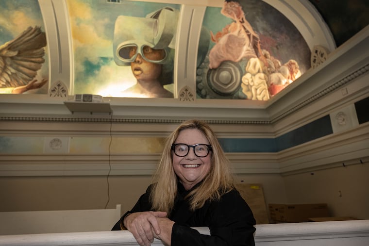 Muralist Meg Saligman, aka the "Ministrix of Awe," poses for a photo on Thursday, Nov. 13, 2025, during a tour of a historic Old City bank she's transforming into a large-scale art installation.