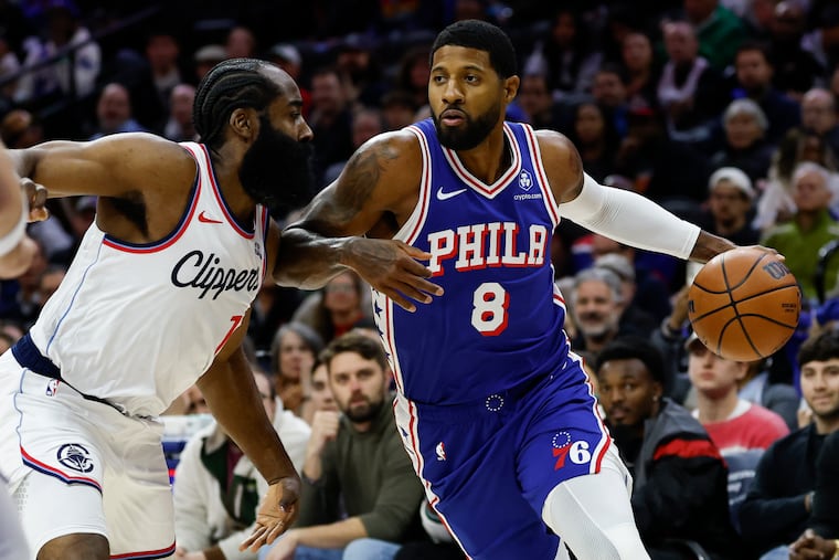 Paul George is defended by Clippers guard James Harden in the first quarter of the Sixers' 110-108 win over Los Angeles on Monday.