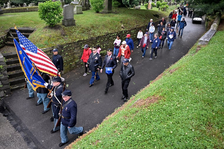Visitors follow the color guard in procession through Laurel Hill Cemetery Sunday, May 24, 2026 during the annual observance of traditional Decoration Day on the Memorial Day weekend. The Gen. George B. Meade Post No. 1, Grand Army of the Republic hosts the event, which included a wreath-laying ceremony, pageantry, music and speeches.