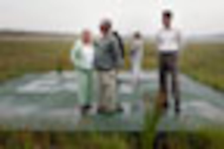 Ed Root, whose cousin was flight attendant Lorraine Bay, President of Families of Flight 93 and his wife Nancy stand at the "sacred ground," the impact area of Flight 93, with Paul Murdoch, right, architect of the Flight 93 National Memorial, at the crash site in Shanksville, Pa, July 27, 2007. The sacred ground is still closed to visitors and is only accessable by the families of the passengers and crew who died on 9/11. Family members of the victims and organizers hope to have the permanent memorial built by the 10th anniversary of the 9/11 attacks. (Laurence Kesterson/Inquirer) EDITORS NOTE: SFLIGHT11, 7/29/07, Permanent memorial at Flight 93 crash site for 9/11 anniversary story.
