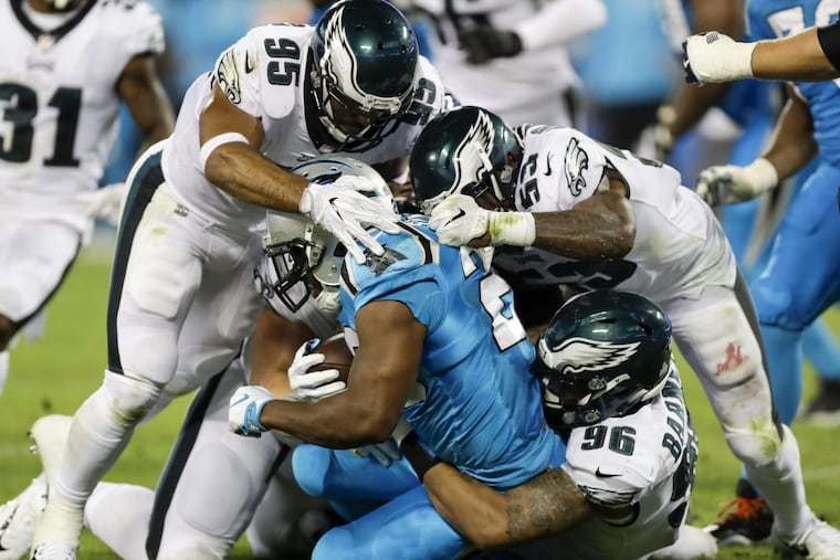 Philadelphia Eagles outside linebackers Mychal Kendricks and Nigel Bradham, and defensive end Derek Barnett, stop Carolina Panthers running back Jonathan Stewart during the third quarter at Bank of America Stadium in Charlotte, N.C., on Thursday, Oct. 12, 2017. The Eagles won, 28-23. (Yong Kim/Philadelphia Daily News/TNS)
