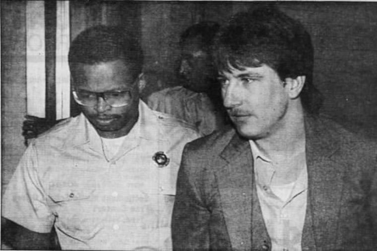 Arnold Mulholland, left, led to a hearing in City Hall in 1989 after he had been arrested and accused of killing three gay men during a weeklong killing spree. Mulholland was found dead in prison on June 8, 2018, according to state officials.