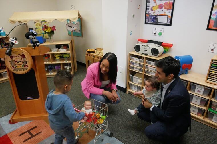 County Commissioners Jamila Winder and Neil Makhija and their children at a news conference announcing the expansion of paid parental leave to 12 weeks for employees of Montgomery County.
