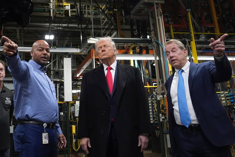 President Donald Trump listens to Corey Williams (left), plant manager, and Bill Ford, executive chairman of Ford, during a tour of the Ford River Rouge plant complex, Tuesday, Jan. 13, 2026, in Dearborn, Mich.