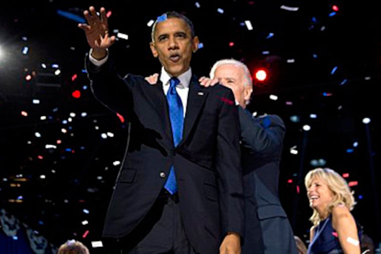 President Barack Obama and Vice President Joe Biden celebrate on stage at the election night party at McCormick Place, Wednesday, Nov. 7, 2012, in Chicago. Obama defeated Republican challenger former Massachusetts Gov. Mitt Romney. (AP Photo/Carolyn Kaster)