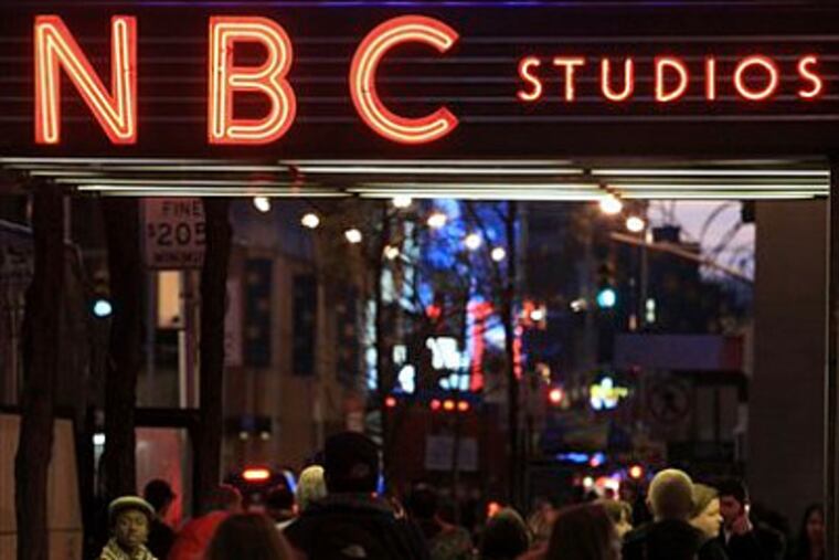 FILE - In this Aug. 21, 2009 file photo, the NBC logo glows in neon lights at its headquarters in New York. Comcast, the nation's largest cable TV company, says it will complete its takeover of NBC Universal at just before midnight Eastern time, Friday, Jan. 28, 2011. The deal will give Comcast Corp. 51 percent of the fourth-ranked broadcaster NBC, a bevy of cable channels and the Universal Pictures movie studio. It caps a yearlong regulatory review that resulted in conditions meant to keep it from stifling the growth of online video services such as Netflix and Hulu. (AP Photo/Bebeto Matthews, File)