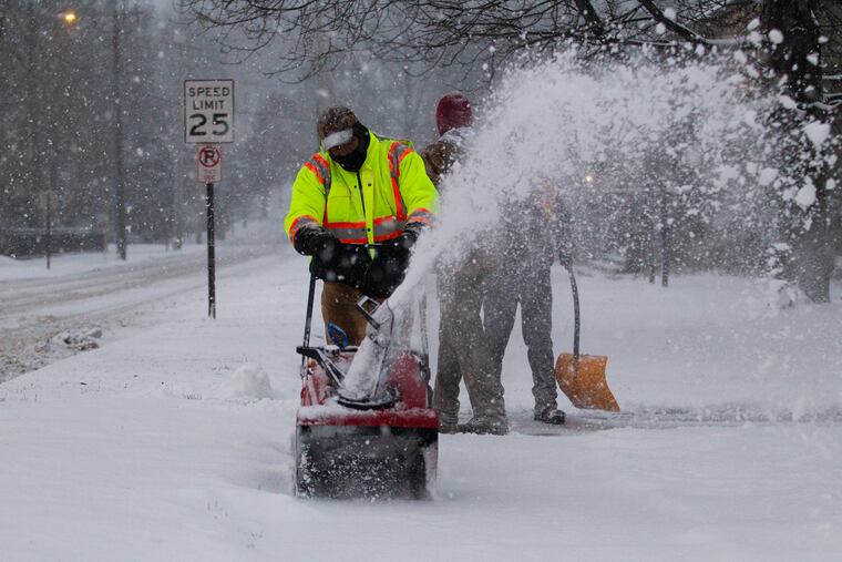Snow is removed from around St. Katherine of Siena Church on Lancaster Ave. in Wayne, PA on Dec. 16, 2020.