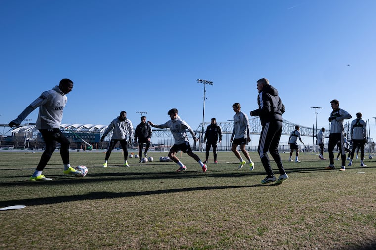 Danley Jean Jacques (left) working in a drill with teammates and manager Bradley Carnell at Tuesday's practice.