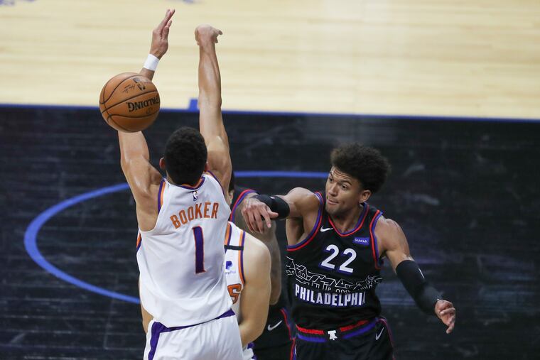 Sixers guard Matisse Thybulle (right) blocks a shot by Phoenix Suns guard Devin Booker on April 21.