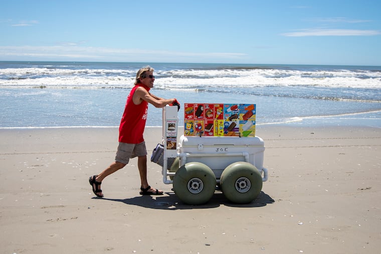 Joe Bisch, 55, of Ventnor City, N.J., is works selling ice cream and popsicles to beachgoers at Ventnor City Beach on Saturday, May 23, 2020, as the Memorial Day weekend got underway.