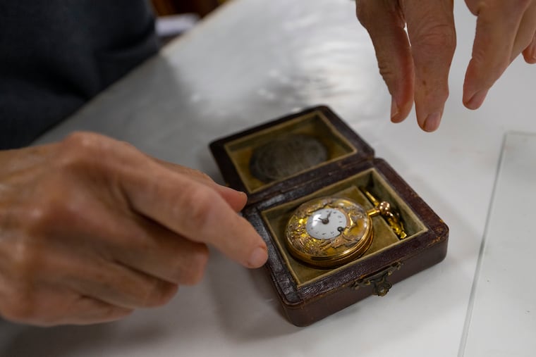 Lynda Cain, of Freeman’s auction house in Philadelphia, handles a golden pocket watch owned by the Marquis de Lafayette. Freeman’s will auction the watch Nov. 12.