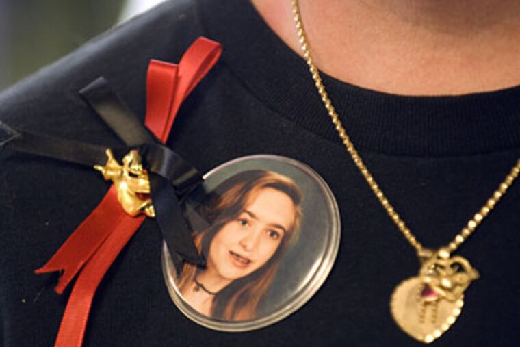 Wendy Lavin wears a photograph of her daughter Jennifer Still who was murdered in 1999. The news that someone is profiting from her child's death, is taking its toll. (Ron Tarver / Staff Photographer)