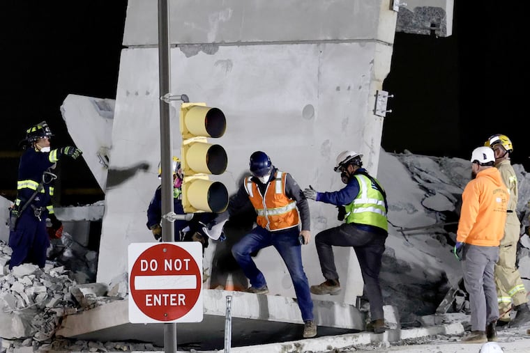 Workers onsite of the partial parking garage in Grays Ferry on Sunday, April 12, 2026 in Philadelphia. The garage has been demolished and the effort has shifted toward recovering the lost ironworkers. .