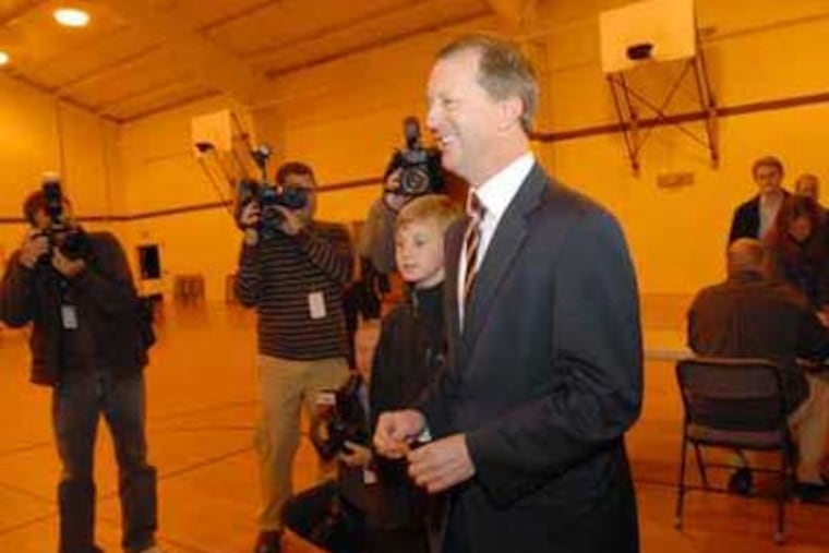 John Adler seen voting in Cherry Hill with son, Oliver Adler, 9, during last year's election. (April Saul / Staff Photographer)