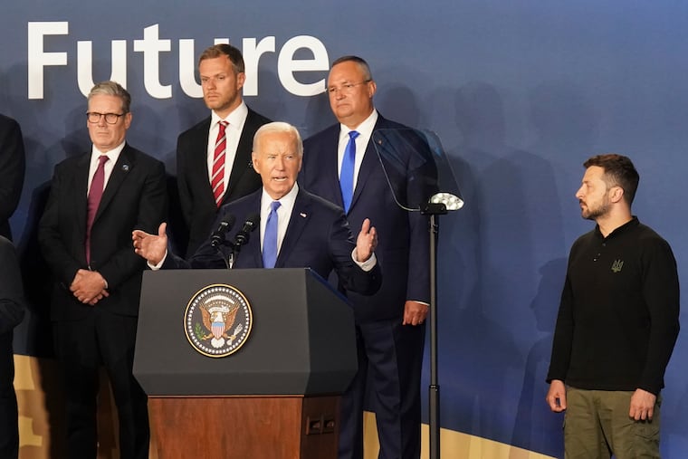 Ukrainian President Volodymyr Zelensky (right) looks on as President Joe Biden speaks during July's NATO Summit in Washington. Before real peace talks are an option, Biden must green light long-range Ukrainian strikes inside Russia — and convince NATO to invite Kyiv to join the group, writes Trudy Rubin.