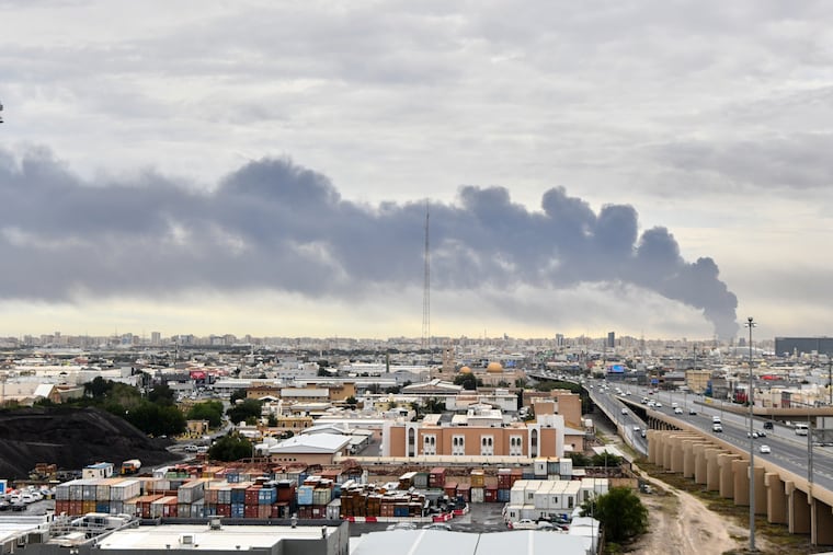Smoke rises from Kuwait international airport after a drone strike on fuel storage in Kuwait City, Kuwait, Friday, Wednesday, March 25, 2026.