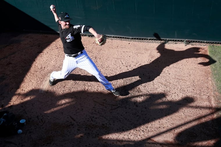 Chicago White Sox relief pitcher Danny Farquhar warms up in the bullpen during the sixth inning of the team's spring training baseball game against the Los Angeles Dodgers in Glendale, Ariz. on March 2. Farquhar was taken to a hospital after he passed out in the dugout Friday.