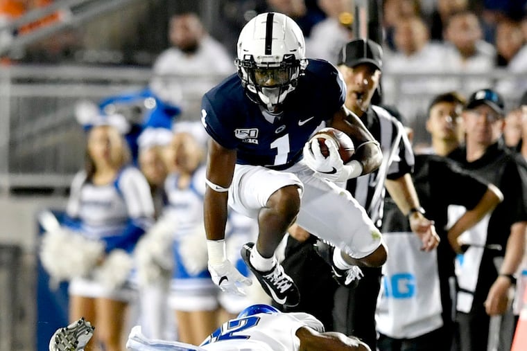 Penn State wide receiver KJ Hamler leaped over a Buffalo defender during Saturday's game.