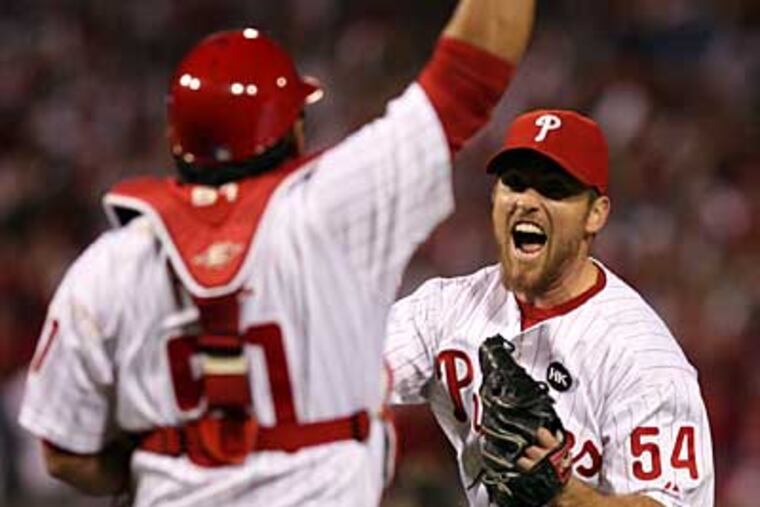 Brad Lidge and Carlos Ruiz celebrate the end of Game 5 of the NLCS. ( Yong Kim / Staff Photographer )