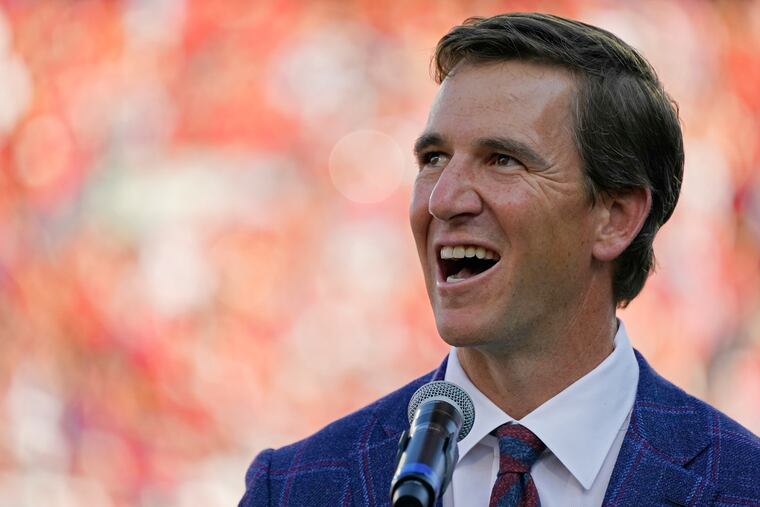 Eli Manning, pictured at his Ole Miss jersey retirement in 2021, will serve as an executive producer of a Hulu television show based on his fictional Penn State quarterback Chad Powers character.