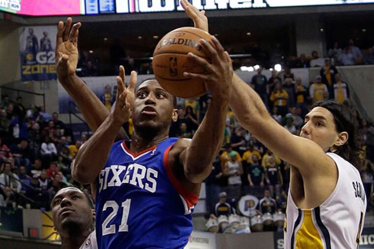 76ers forward Thaddeus Young drives between Pacers defenders Ian Mahinmi and Luis Scola during the first half. (AJ Mast/AP)