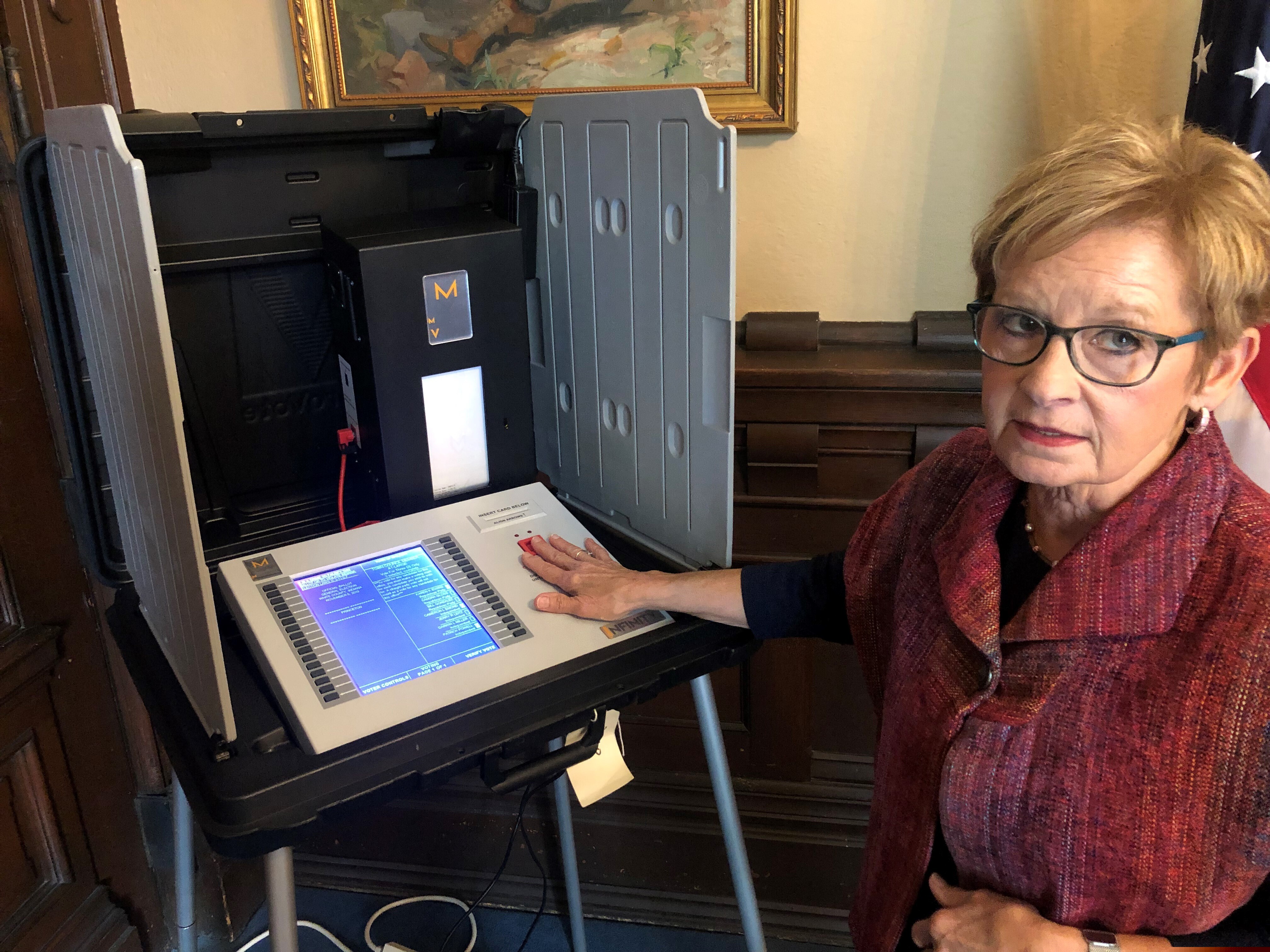 Indiana Secretary of State Connie Lawson demonstrates an upgraded voting machine that the state is now using.