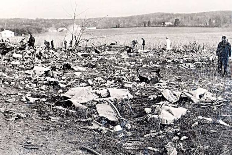 Emergency personnel sift through debris after a plane crashed in Elkton, Md. on December 8, 1963, killing 81 people. Officials blamed the crash of the Boeing 707 en route from Puerto Rico to Philadelphia on a lightning strike. (AP Photo/Cecil County Dept. of Emergency Management)