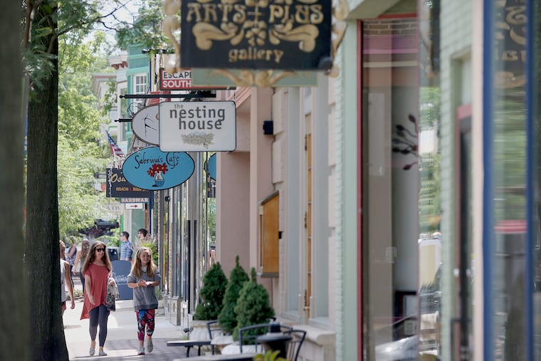 People stroll past small businesses on Haddon Avenue in downtown Collingswood.