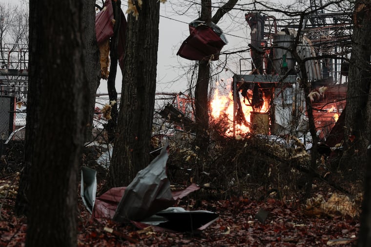 Flames and debris from an explosion are seen in Logan Township, N.J. Wednesday, March 4, 2026.