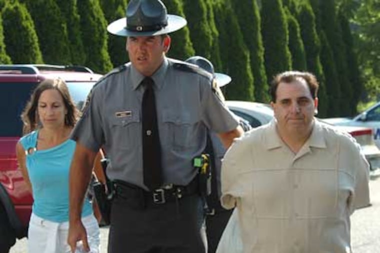 Nicholas "Nicky the Hat" Cimino (right) and his girlfriend Gayle Hudson, are led to District Justice in Media by State Police in July 2008. Cimino reached a plea agreement today. (Clem Murray / Staff File Photo)