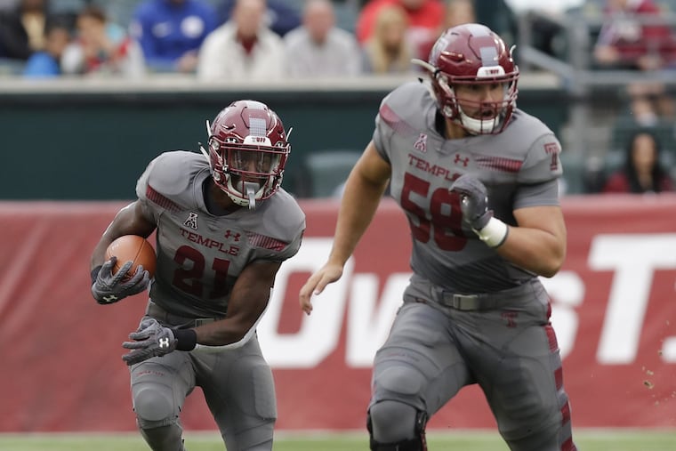 Temple wide receiver Randle Jones follows the blocking off center Matt Hennessy in a game last year. YONG KIM / Staff Photographer
