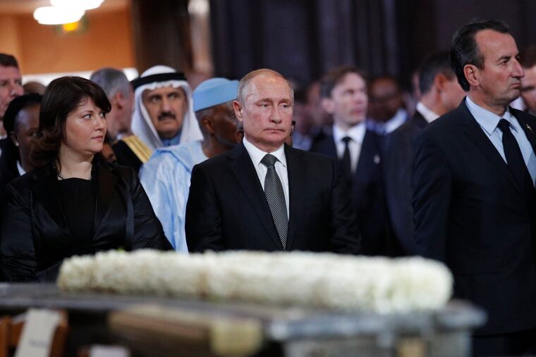 Russian President Vladimir Putin, center, stands before a service for late French President Jacques Chirac at the Saint Sulpice on Monday, Sept. 30, 2019 in Paris. Past and current heads of states are gathering in Paris to pay tribute to former French President Jacques Chirac who died last week at the age of 86.