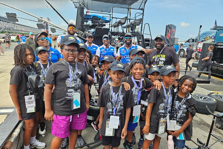 Urban Youth Racing School students participate in an outing at a track.
