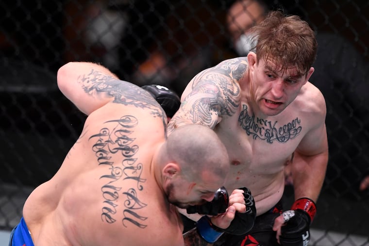 Chris Daukaus punches Parker Porter in their heavyweight bout during the UFC 252 event at UFC APEX on August 15, 2020 in Las Vegas, Nevada.