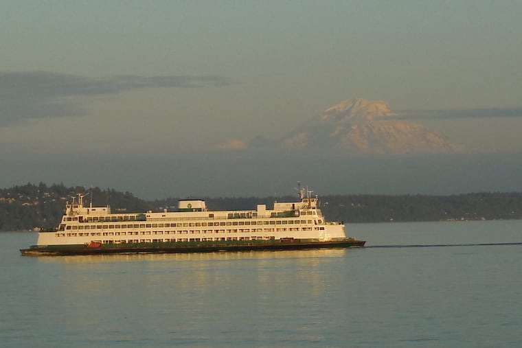 The mountain is out. Mount Rainier and a ferry seen from the deck of a Washington state ferry traveling Puget Sound between Bremerton and Seattle.
