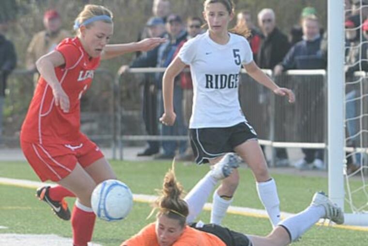 Lenape's Lizzie Kinkler chases a loose ball in front of Ridge goalkeeper Rachel Axt. (Photo: Curt Hudson)