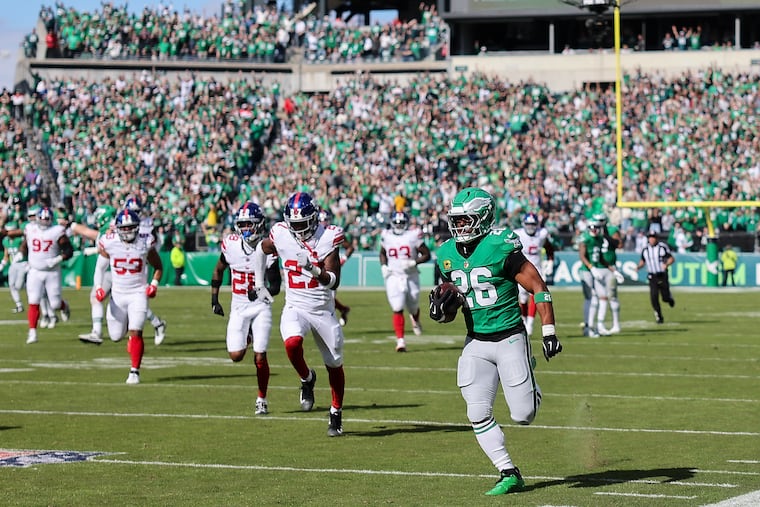 Eagles running back Saquon Barkley races to the end zone for a 65-yard touchdown run against the Giants in the first quarter on Sunday.