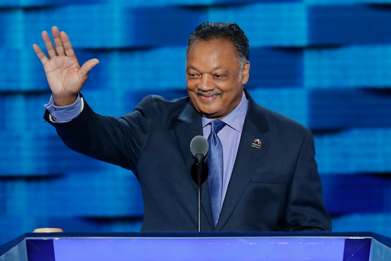 The Rev. Jesse Jackson waves as he steps to the podium during the third day of the Democratic National Convention in Philadelphia on July 27, 2016.