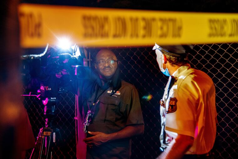 NBC10 photojournalist Pete Kane talks with Philadelphia Police Chief Inspector Scott Small (right) at the scene of a double fatal car crash in Mantua in the early morning Aug. 27, 2020, on of his last nights on the streets. Kane, who started in the mailroom at WCAU 47 years ago and rose to become a legendary TV cameraman, retired last week.
