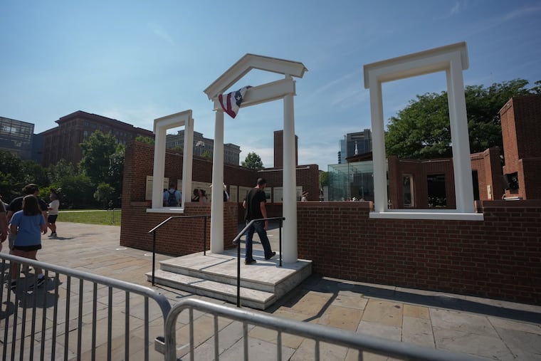 Visitors to the President's House Site, where new panels have been installed, in Philadelphia, July 15, 2026. Historians and advocates have criticized the panels for minimizing Washington's role as an enslaver.