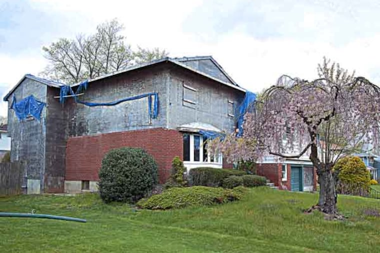 In Cherry Hill, the boarded up, foreclosed home at 14 Glen Lane is a problem for neighbors. ( ED HILLE / Staff Photographer )
