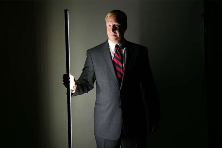 Independence LED CEO Charlie Szoradi holds one of his company's high-efficiency LED lighting tubes, made locally in Wayne with aircraft-grade aluminum. (David Maialetti / Staff Photographer)