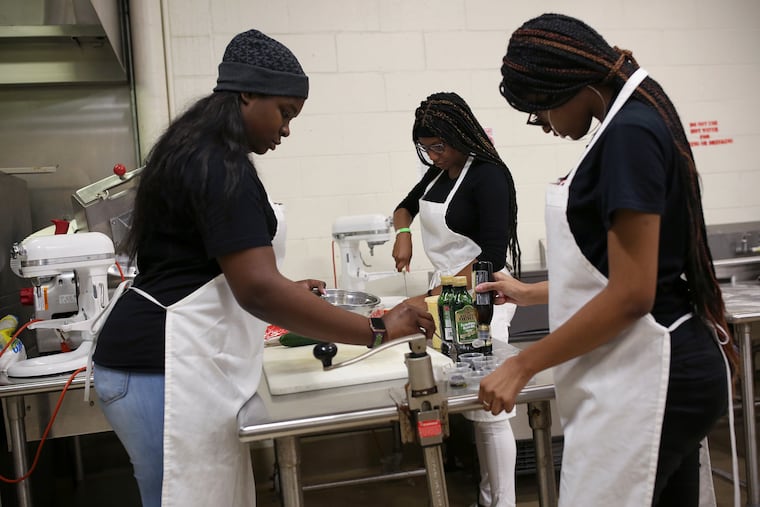Philadelphia School District students, shown in this 2019 photo, prepare food in cooking class. Some schools have had little to no food this year.
