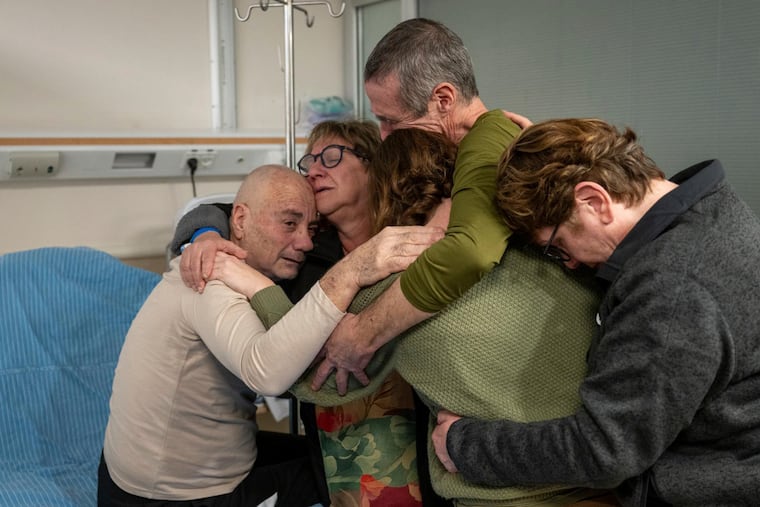 Hostage Luis Har (left) is hugged by relatives after being rescued from captivity in the Gaza Strip.